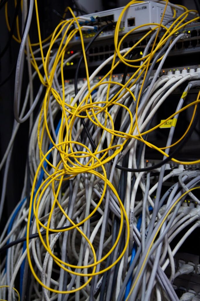 pexels-photo-12266915 Close-up of a messy bundle of network cables tangled in a server rack.