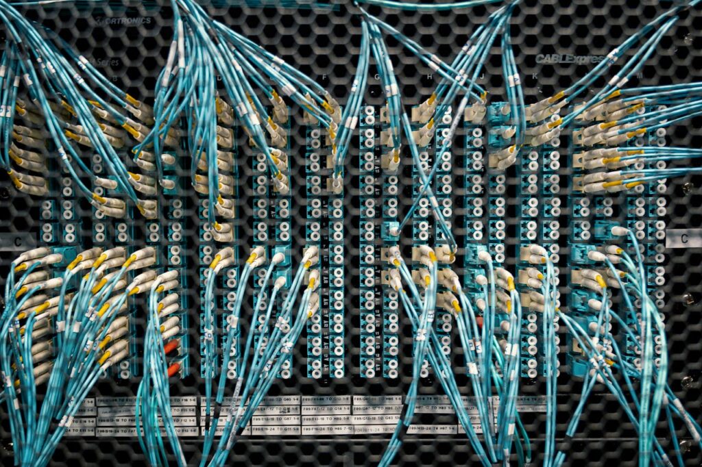 pexels-photo-4497195 Close-up of color-coded fiber optic cables in a data center.